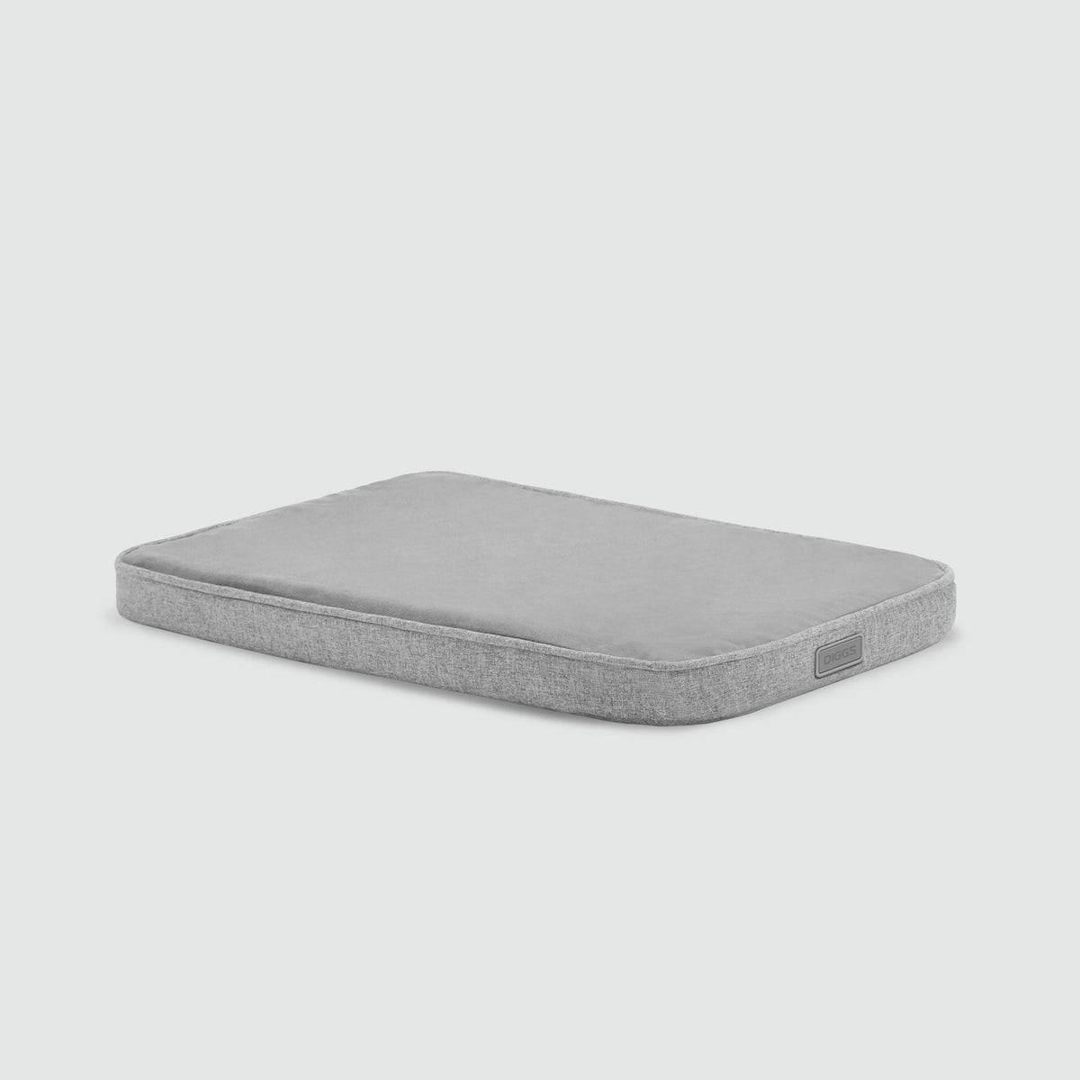 A gray mattress with no sheets on it