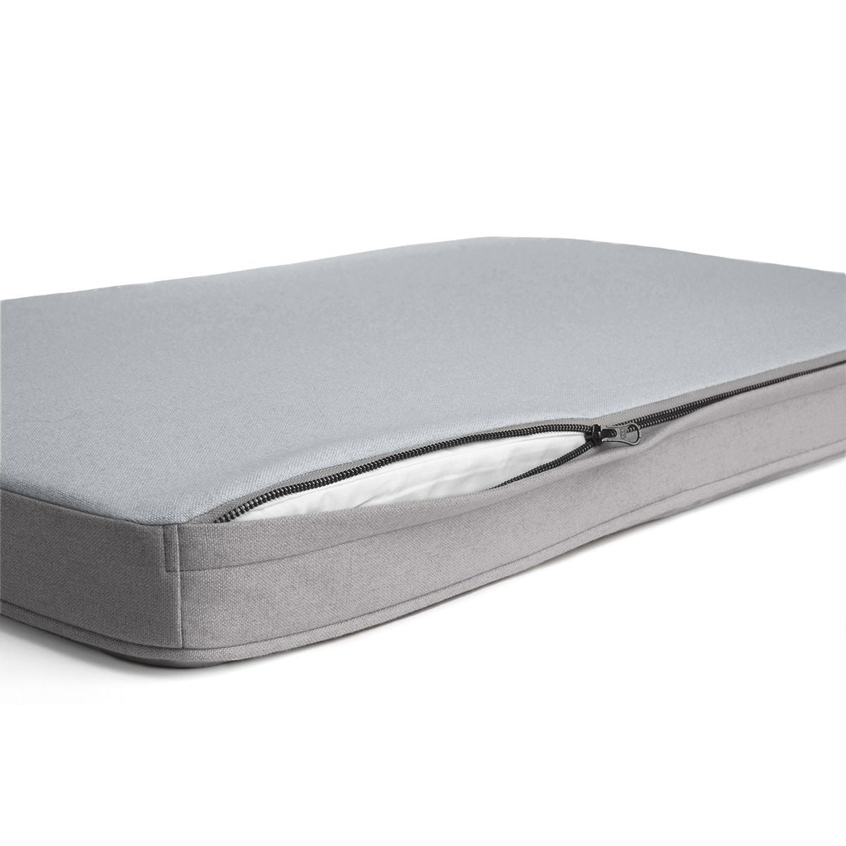 A grey (light grey) Diggs snooz pad with an open zipper.
