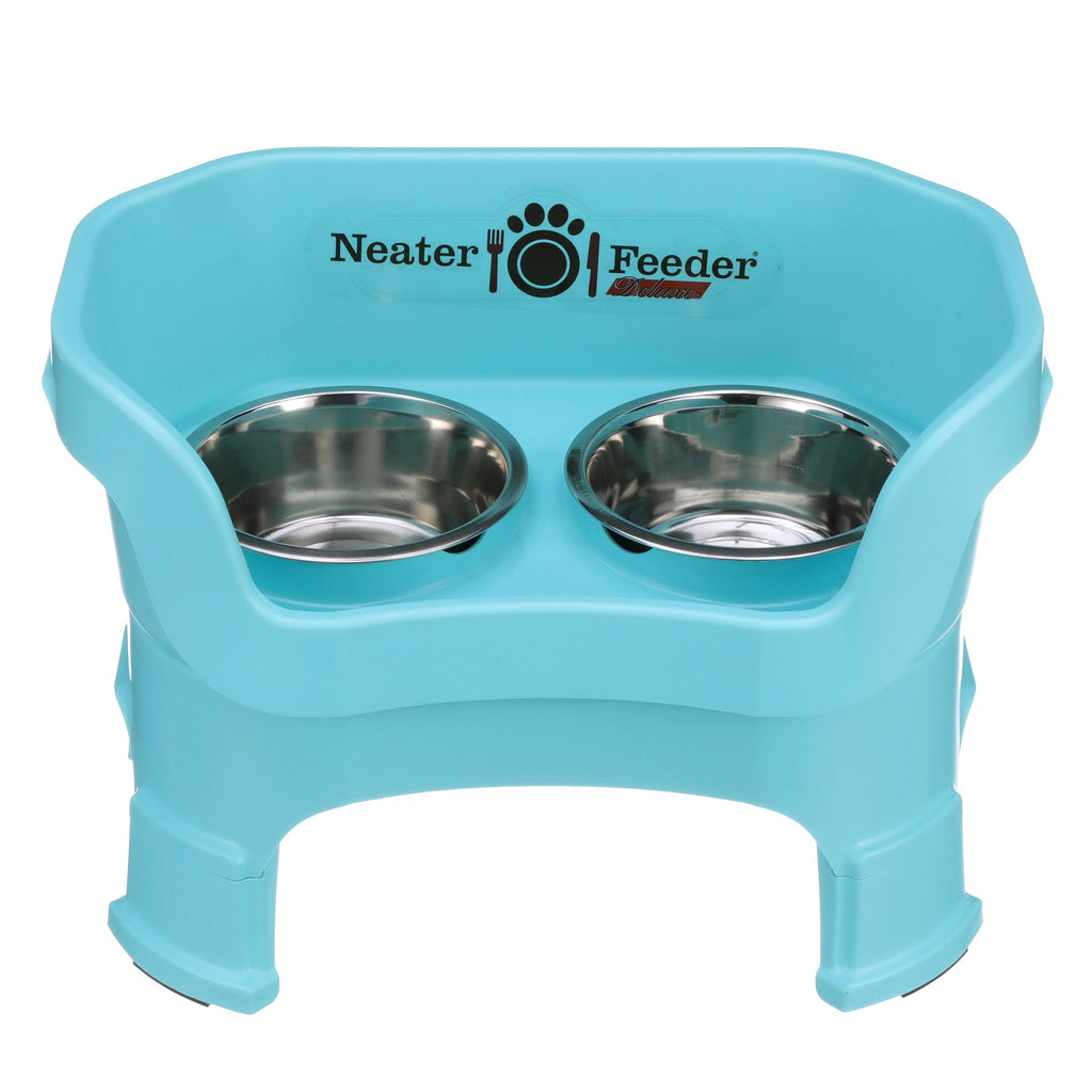 Neater Feeder Deluxe medium with leg extensions in Aqua with two stainless steel bowls against a white background.