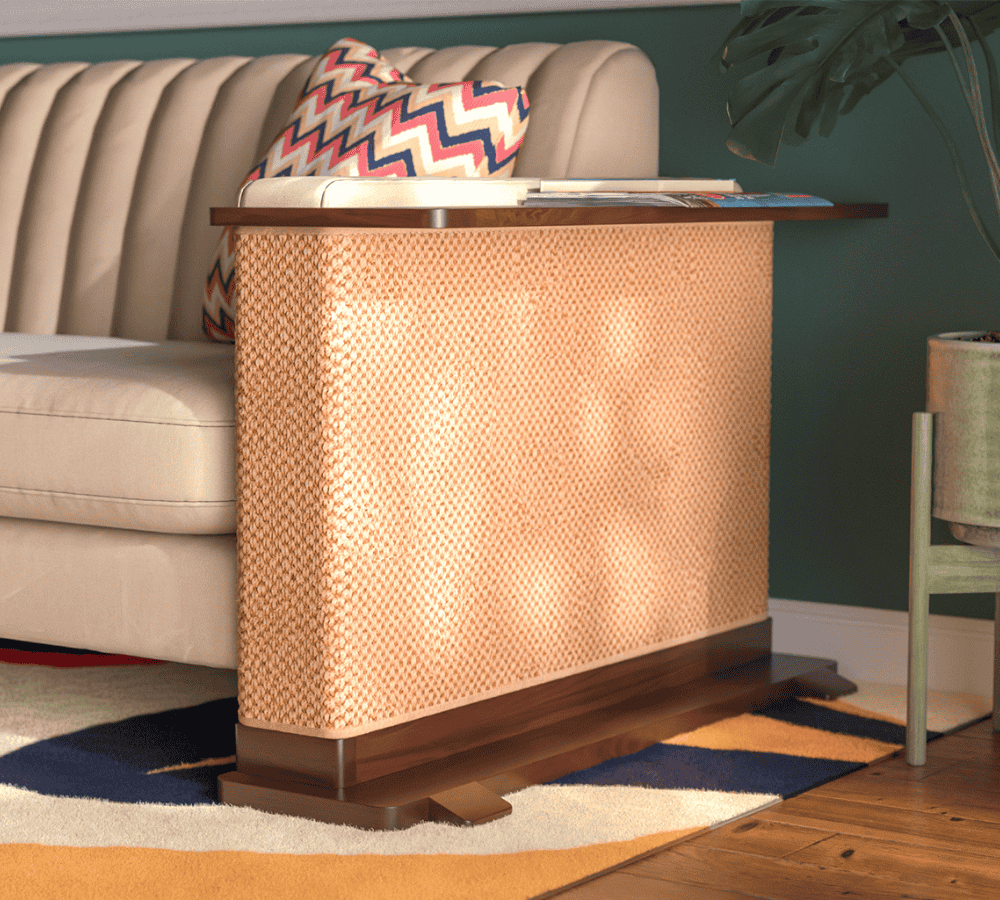 A Cat-e-Corner table placed next to a sofa, integrating a cat's scratching post with a small table, in a room with a plant and a colorful cushion.