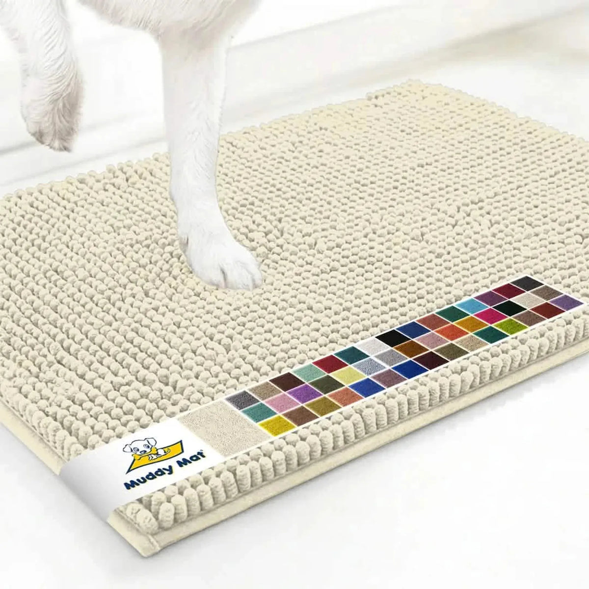 Angled view of Muddy Mat® anti-mud dog door mat in ivory showing plush chenille texture, color swatches, and dog paw on a white floor