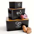 Three-Piece Black Metal Canister Set Labeled for Potatoes, Onions and Garlic in Graduated Sizes